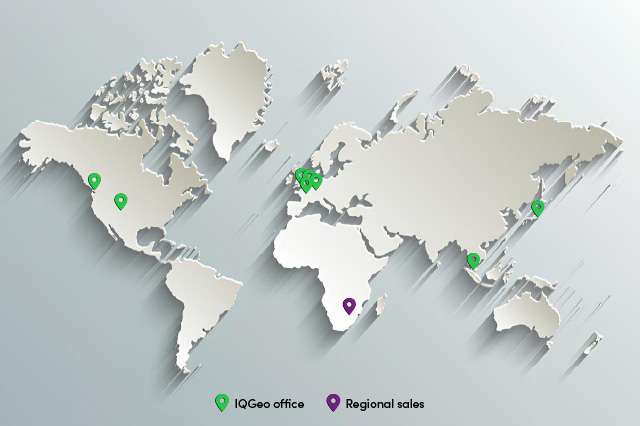 Weltkarte mit grünen Stecknadeln zur Kennzeichnung der IQGeo-Bürostandorte und einer violetten Stecknadel für den regionalen Vertriebsstandort